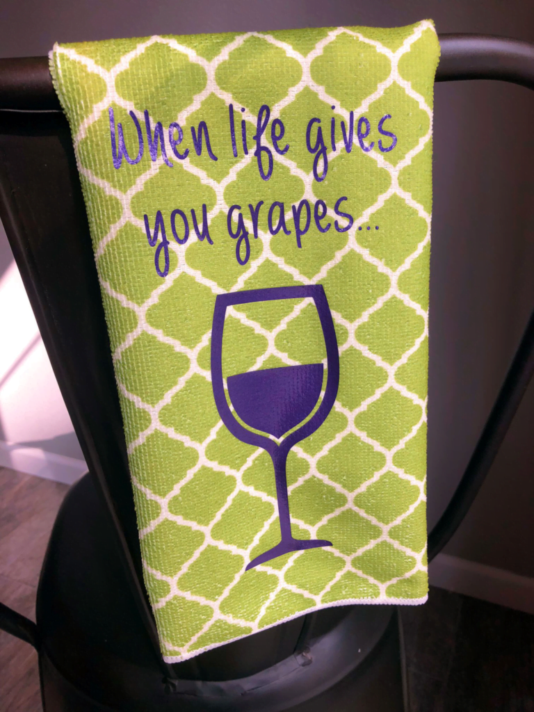 Picture of a green tea towel with a Grape EasyWeed Electric transfer applied