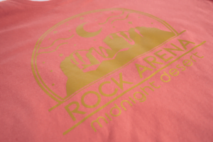 HouseCut heat transfer vinyl from Wellington House Inc - gold rock arena design on salmon colored shirt